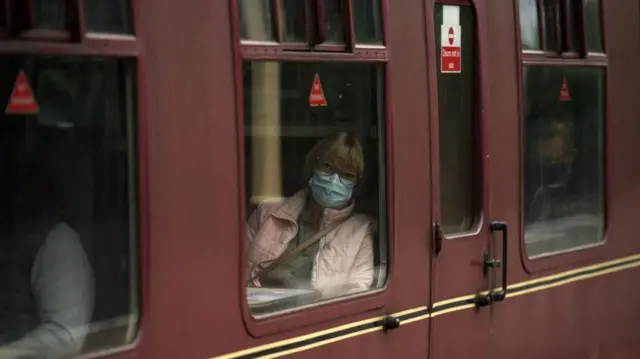 A woman wearing a mask on a train in Lancashire