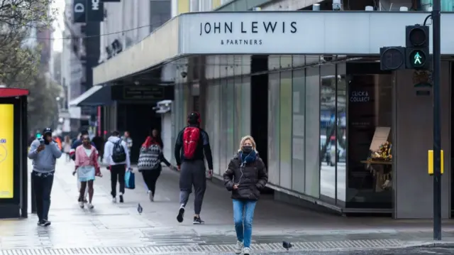 People walk past a John Lewis store