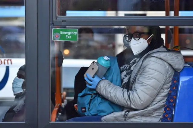 A person wearing a mask on a bus