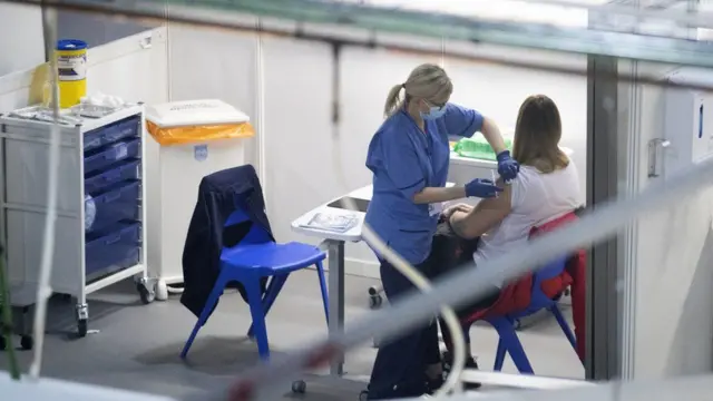 A woman receiving her vaccine