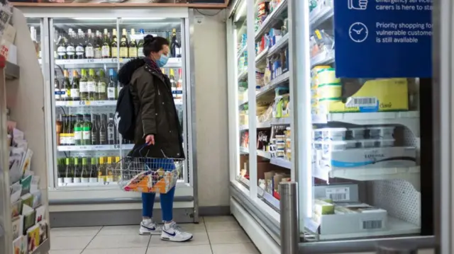 Woman wearing a mask in a shop