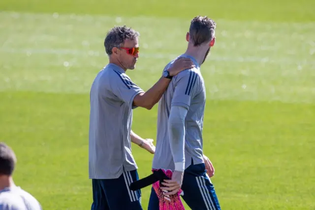 Spain coach Luis Enrique speaks with goalkeeper David de Gea during training at Las Rozas