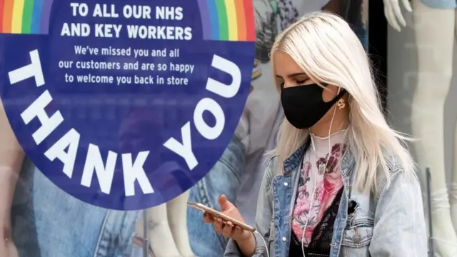 Woman wearing mask outside shop