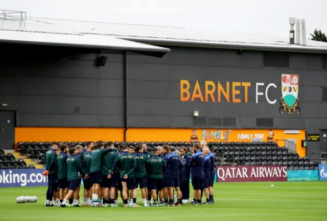 Italy coach Roberto Mancini talks to his players during training at the Hive in Barnet