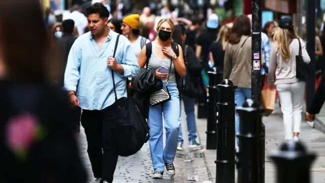 A woman wears a mask