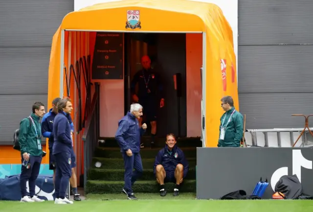 Italy coach Roberto Mancini sat at the entrance to the tunnel before his team train at the Hive in Barnet