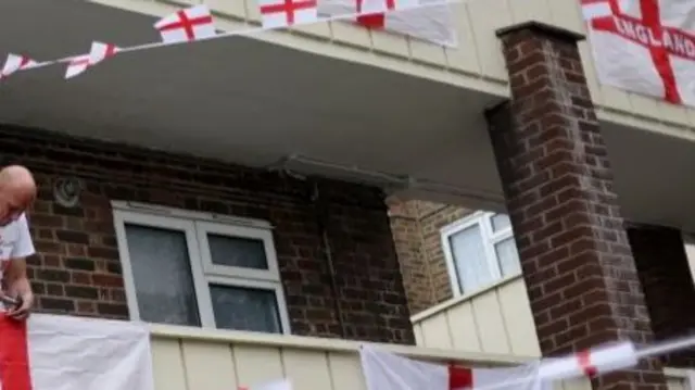 England flags hanging outside flats