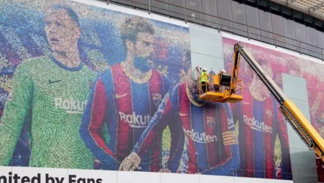 A poster of Messi is removed at Barcelona's stadium