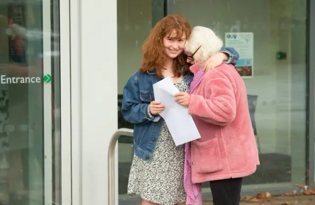 Leila Jarvis hugs her mother (name not given) after receiving her grades at Kensington Aldridge Academy in London