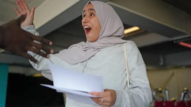 Amira Adrwish reacts as she opens her GCSE results