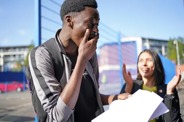 Joy Israel Mbengo celebrates with his headteacher at City Academy in Birmingham