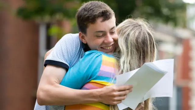 Noah Dunstan hugs his mum after opening his GCSE results at Ffynone House School in Swansea