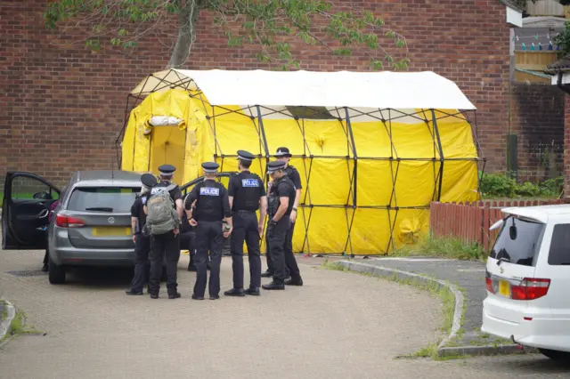 Polce tent with officers