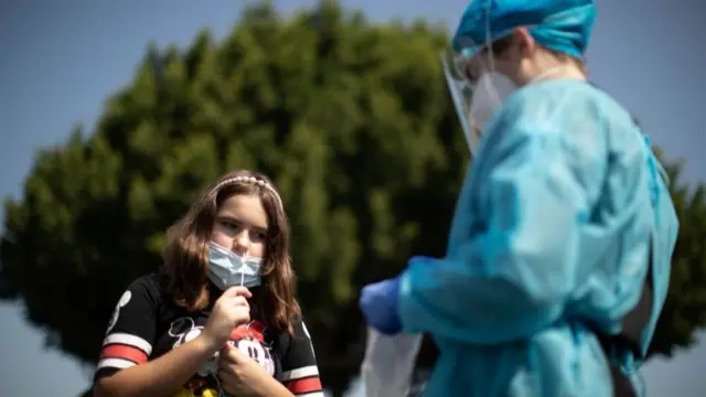 Brianna Norzagaray, 10, takes a Covid test at a back-to-school clinic in South Gate, Los Angeles,