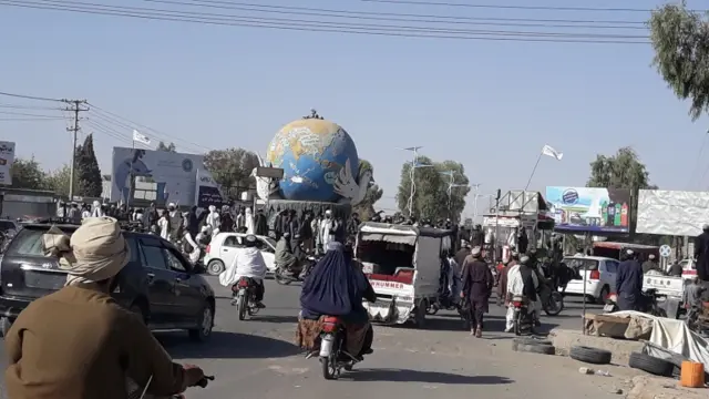 Taliban militants gather after taking control of Lashkar Gah, the provincial capital of Helmand