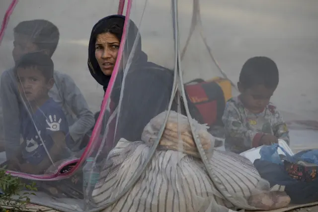 Displaced Afghans sit in a tent at a makeshift IDP camp in Share-e-Naw park to various mosques and schools on August 12, 2021 in Kabul, Afghanistan