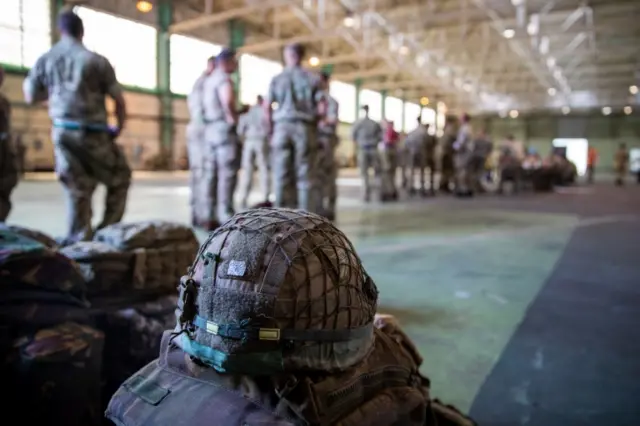 UK troops board a flight as they are deployed to Afghanistan