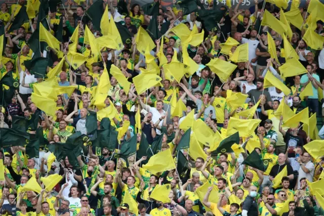 Norwich City fans waving flags at their Premier League opener for 2021-22 at home to Liverpool