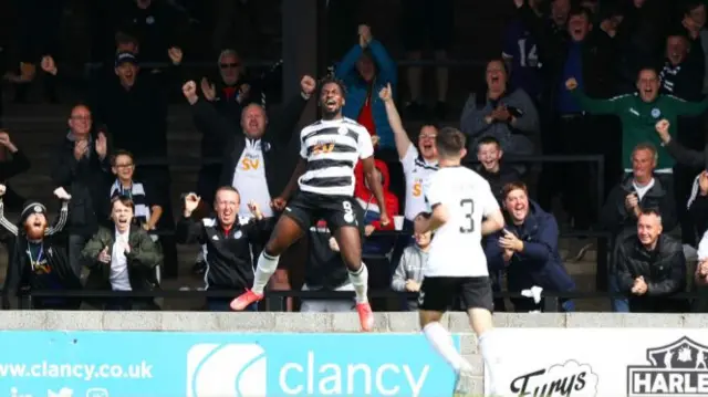 Tomi Adeloye celebrates after scoring to make it 1-0 Ayr