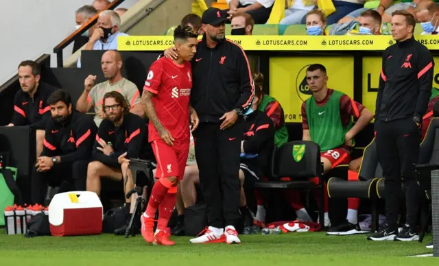 Roberto Firmino prepares to come on for Liverpool