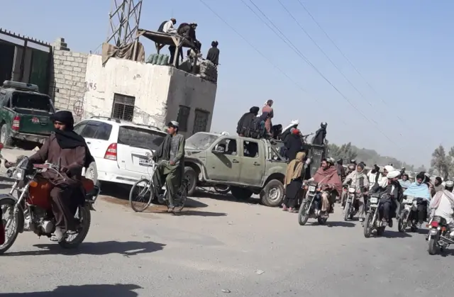 Taliban militants gather after taking control of Lashkar Gah, the provincial capital of Helmand,  on 13 August 2021