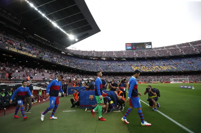 Barcelona players enter the pitch