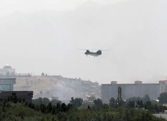 A military helicopter flies over Kabul