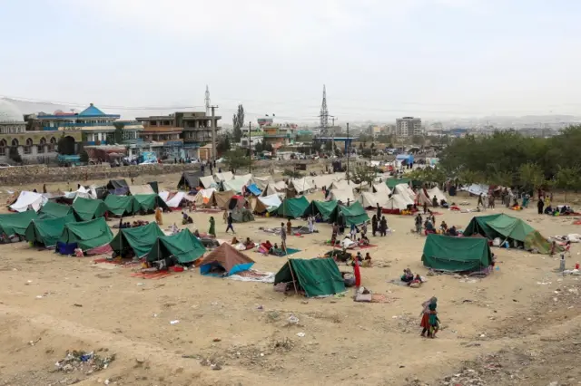 Wide view of families living in makeshift camps in a public park in Kabul