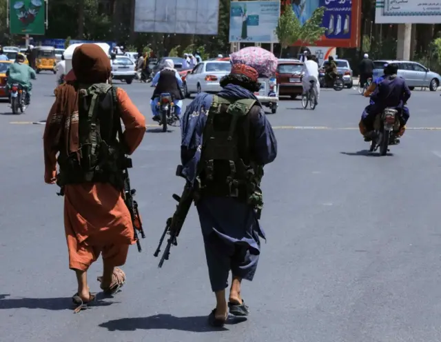 Taliban forces patrol a street in Herat, Afghanistan