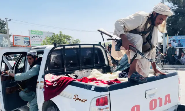 Taliban members are seen near Hamid Karzai International Airport as thousands of Afghans rush to flee the Afghan capital of Kabul