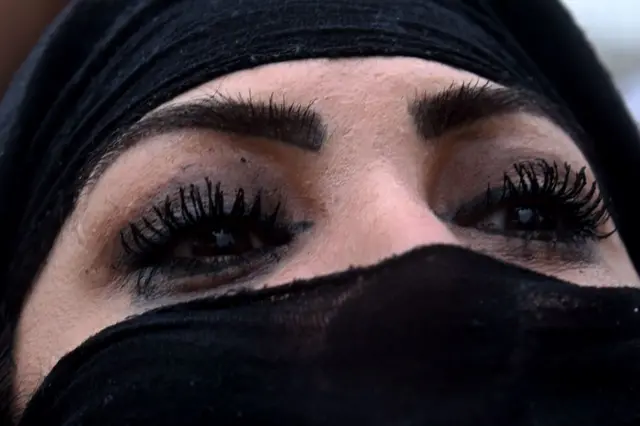 An Afghan protester looks on as demonstrators shout slogans during a rally in front of the Supreme Court in Kabul on March 24, 2015,