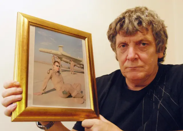 Graham Knight holding a photograph of his son Ben Knight