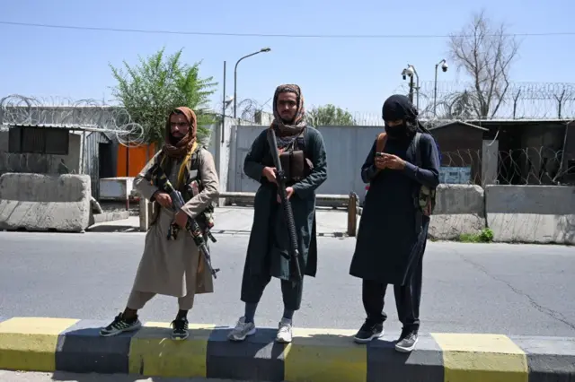 Taliban stand guard on a street in Kabul