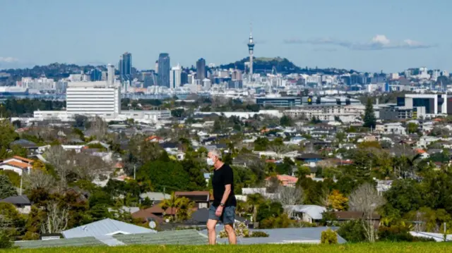 A man takes a walk while wearing a mask in Auckland