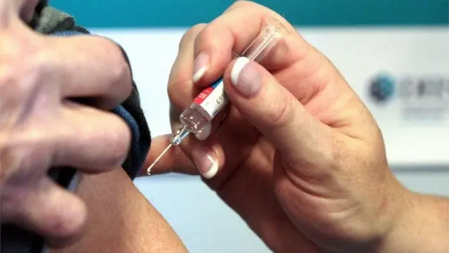 A vaccine about to be given