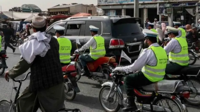 Traffic Police uses Taliban"s flag on their motorcycles as they arrive on their duties in Kandahar, Afghanistan, 17 August 2021