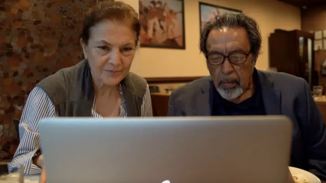 Fawzia Etemadi and Hamid Naweed watch Biden's speech