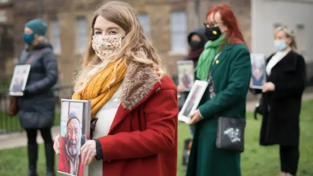 Jo Goodman holding a picture of her father, who died with coronavirus, at a Covid-19 Bereaved Families for Justice event in London