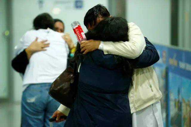 People hug at Frankfurt Airport