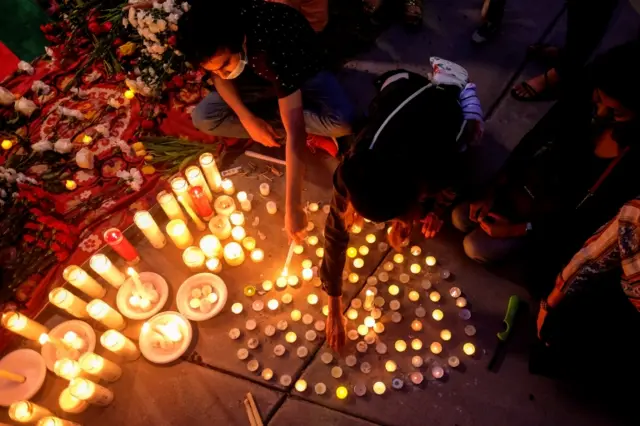 People attend a vigil for Afghanistan outside the West LA Federal Building in Los Angeles, California