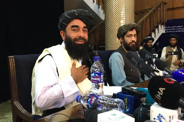 Taliban spokesperson Zabihullah Mujahid (L) attends the first press conference in Kabul on August 17, 2021, following their stunning takeover of Afghanistan.