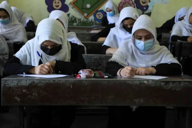 Schoolgirls attend class in Herat on August 17, 2021, following the Taliban stunning takeover of the country