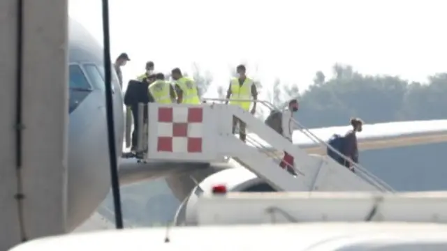 People disembark from a military plane at Fiumicino airport after being brought out of Afghanistan, in Rome, Italy