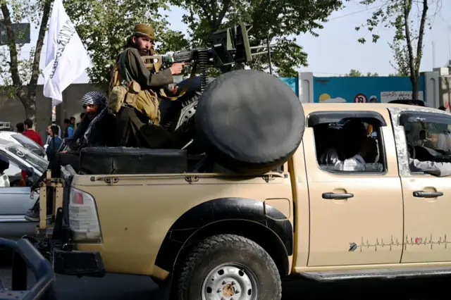 Taliban fighters travel through Kabul on 19 August, 2021