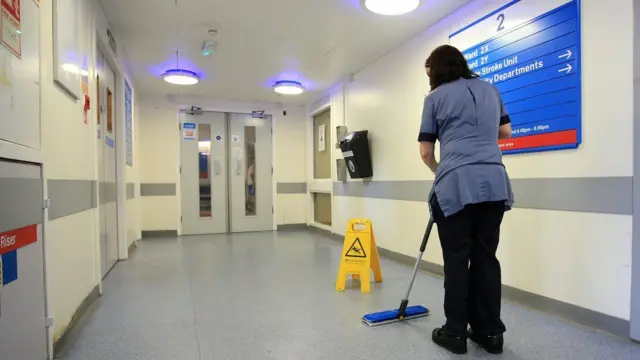 Someone cleaning the floor in a hospital