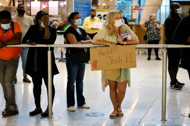 People welcoming travellers at Heathrow