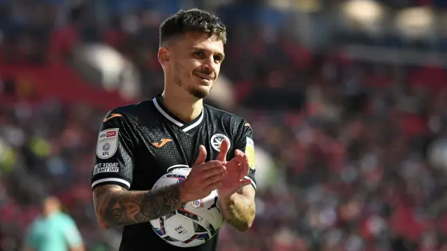 Jamie Paterson of Swansea City applauds fans