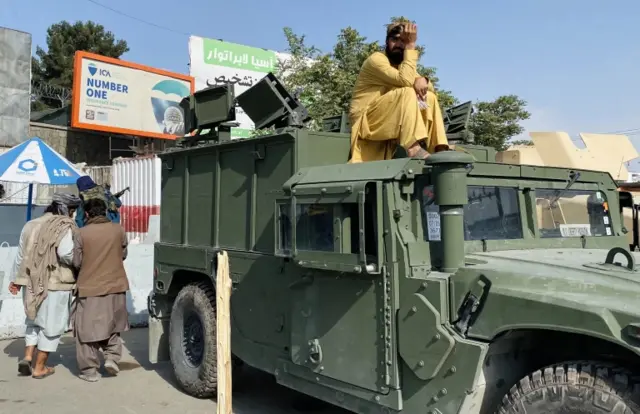 Taliban militants outside Hamid Karzai airport in Kabul on 20 August 2021