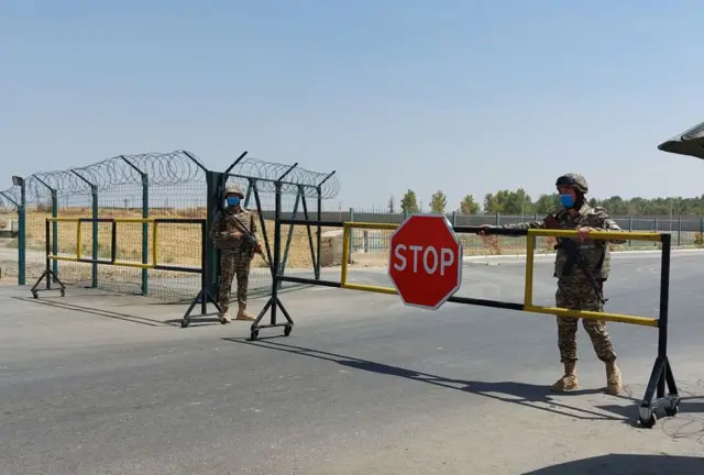 Uzbek soldiers guard a checkpoint, two kilometres from "Friendship Bridge" over the Amu Darya river, which separates Uzbekistan and Afghanistan