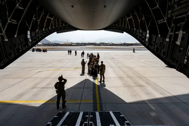 A U.S. Air Force security forces raven, assigned to the 816th Expeditionary Airlift Squadron, maintains a security cordon outside a U.S. Air Force C-17 Globemaster III aircraft in support of Operation Allies Refuge at Hamid Karzai International Airport in Kabul, Afghanistan, August 20, 2021.